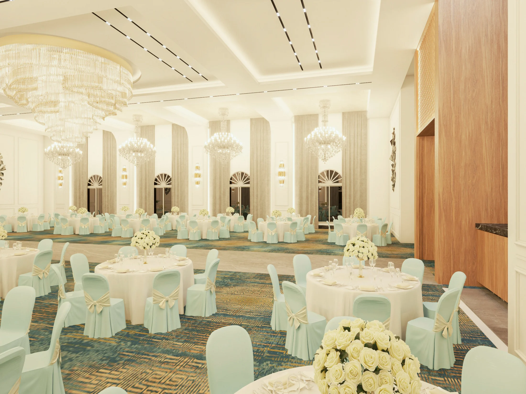 Hospitality banquet hall with chandeliers, arched windows, round tables, and a warm event setting.
