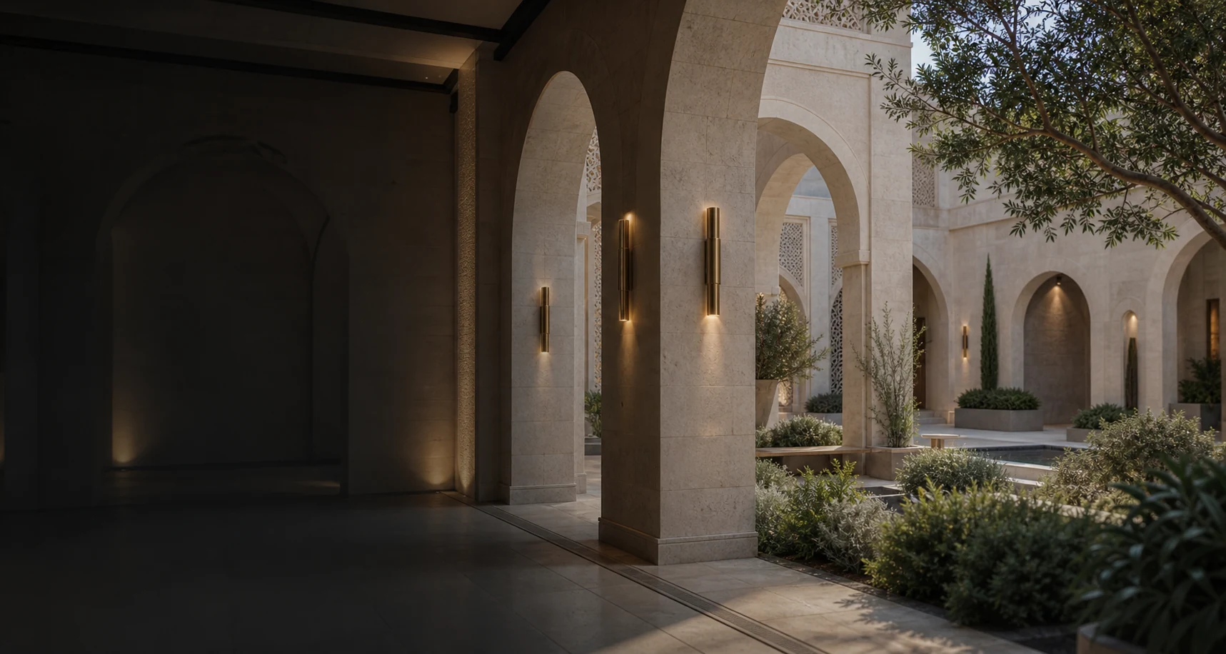 Renewed arched stone courtyard and interior transition showing adaptive reuse, integrated systems, planting, and efficient long-term performance.